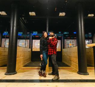 AXED owners standing in front of the axe throwing lanes