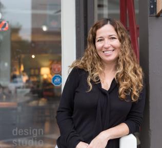C&G Owner Mel in front of the store window
