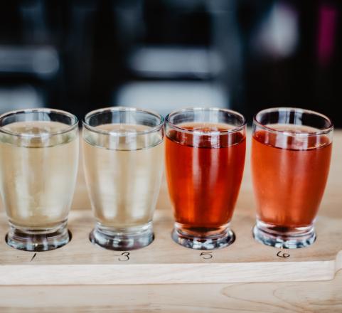 Four glasses of cider on a tasting paddle